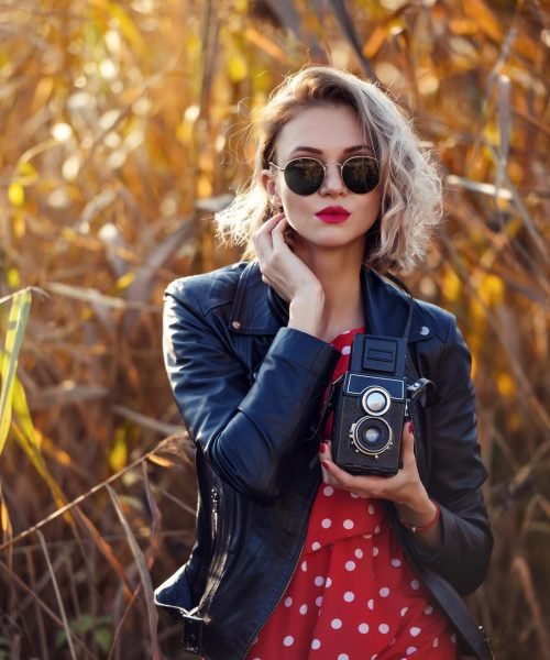 stylish-woman-holding-vintage-camera-in-tall-grass-2026-03-24-00-28-47-utc (2)